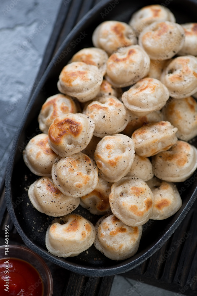 Close-up of fried russian meat dumplings or pelmeni, high angle view Close-up of fried russian meat dumplings or pelmeni, high angle view