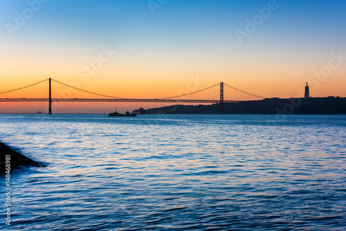 April 25th Bridge and Christ the King statue in Lisbon Portugal at sunrise