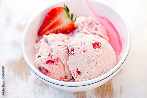 Strawberry cream ice cream in white bowl 