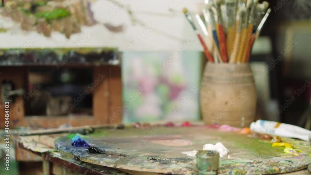 An elderly artist writes a picture in his studio 4k An elderly artist writes a picture in his studio 4k