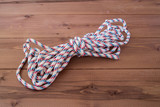 Striped nylon rope on a wooden background.