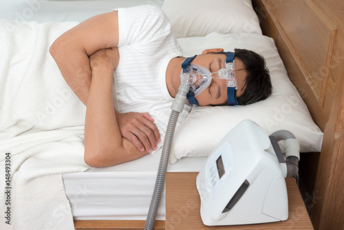Sweet dream during long deep sleep.Continuous positive airway pressure  ,CPAP sleep apnea therapy.Happy and healthy senior man  breathing more easily during sleep without snoring .