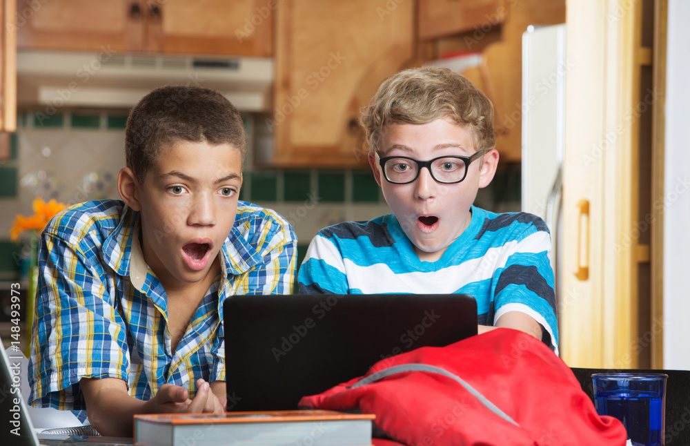 Surprised students looking at computer