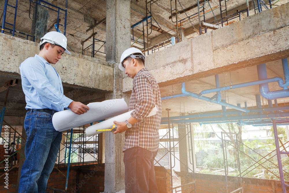 Engineer and foreman discussing in building construction site Engineer and foreman discussing in building construction site