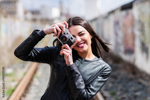 Attractive girl takes pictures with an old camera © johnalexandr
