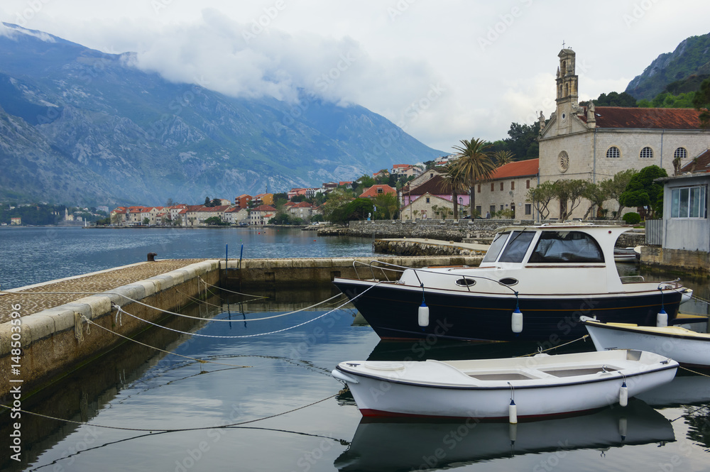 Fototapeta premium Evening landscape with moored boats in Kotor Bay, Montenegro