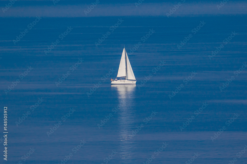 white sailing boat on the blue sea