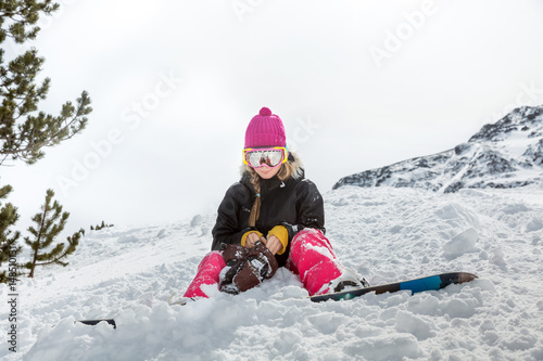 Upset woman snowboarder in mountains