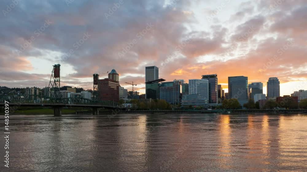Colorful sunset and clouds over Portland Oregon downtown city skyline with Hawthorne bridge and water reflection along Willamette River ultra high definition 4k time lapse movie 4096x2304 uhd