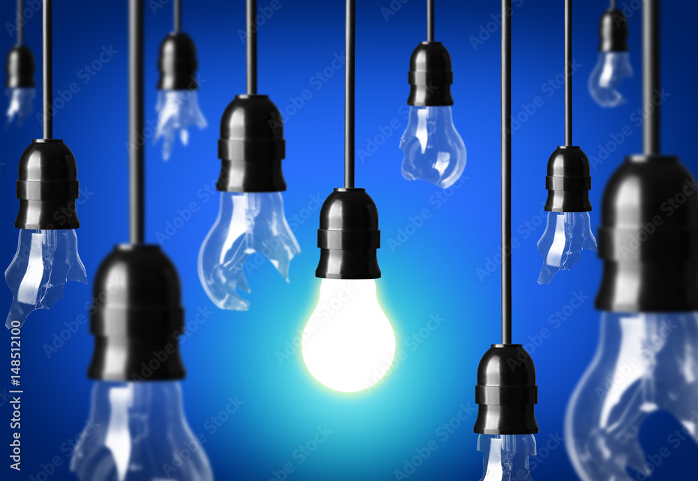 Idea concept with broken bulbs and one glowing bulb Idea concept with broken bulbs and one glowing bulb
