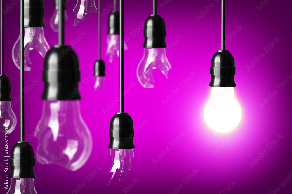 Idea concept with broken bulbs and one glowing bulb Idea concept with broken bulbs and one glowing bulb