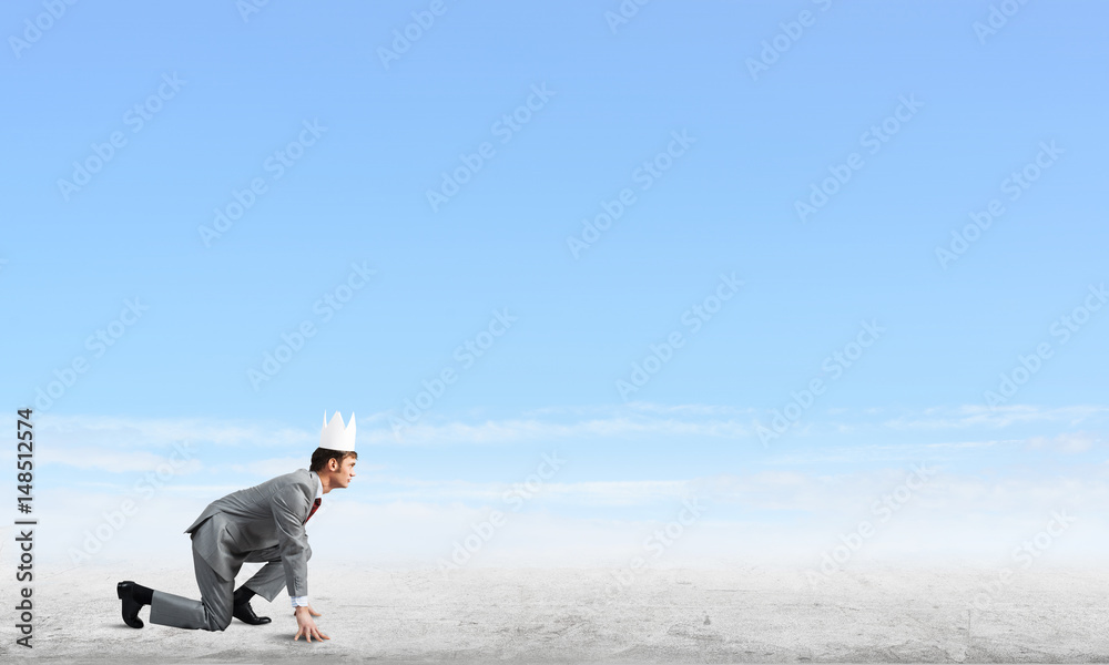 King businessman in elegant suit running and blue sky at background King businessman in elegant suit running and blue sky at background