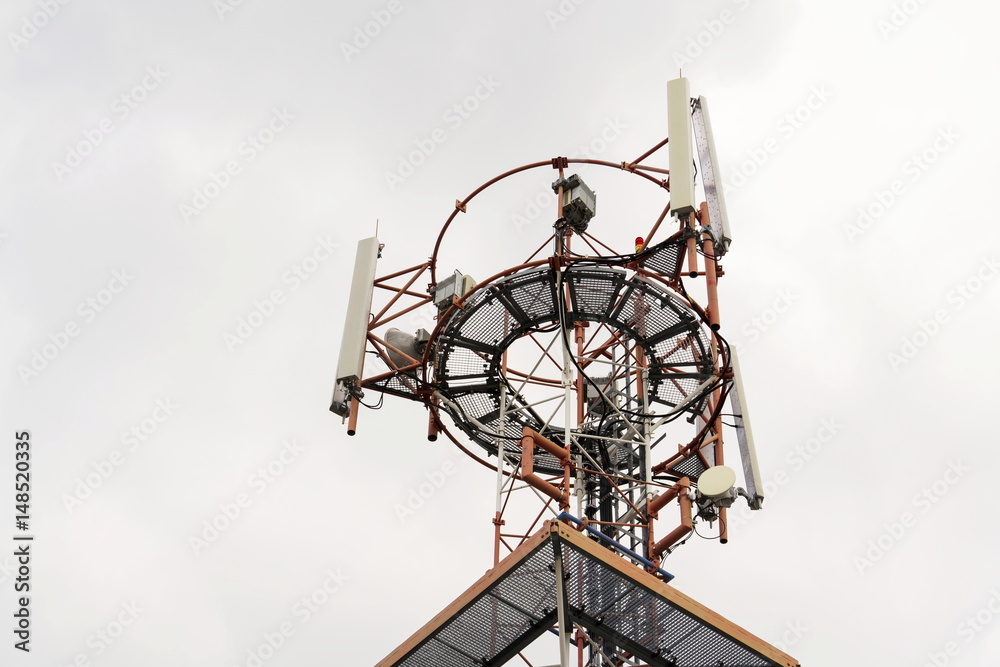 Transmitters and aerials on telecommunication tower during sunset Transmitters and aerials on telecommunication tower during sunset