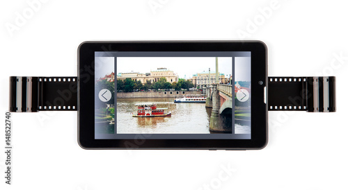 Photographic film under the tablet computer. The concept of digitizing and archiving.