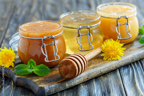 Buckwheat, linden and flower honey in glass jars. photo
