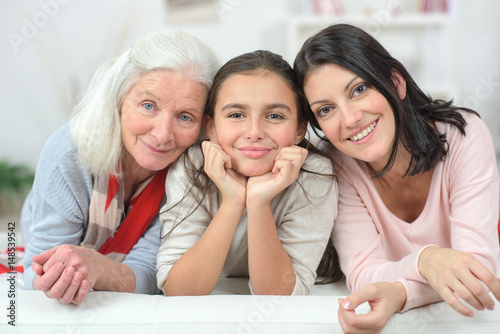 Tableau sur toile Three generation of women on a sofa