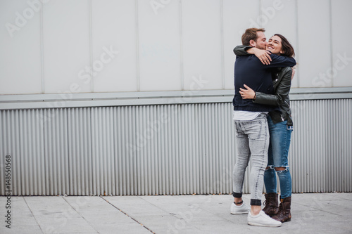 Couple having fun. Couple embracing. Friends giving each other a hug. Reunion. Farewell.
