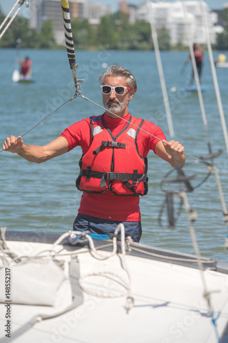 portrait of mature sportsman near catamaran © auremar