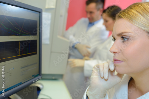 Medical technician looking at computer screen with concern