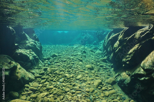 Rocks and pebbles underwater in a river with clear freshwater, Dumbea, New Caledonia, south Pacific