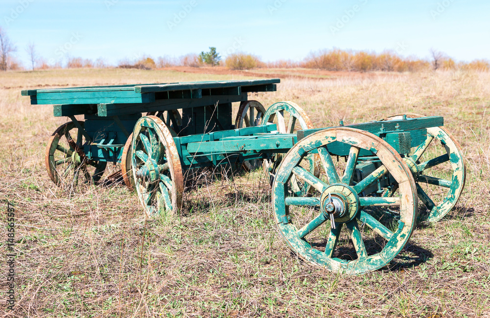 Country life. Old wooden carts without a horses stand at the field