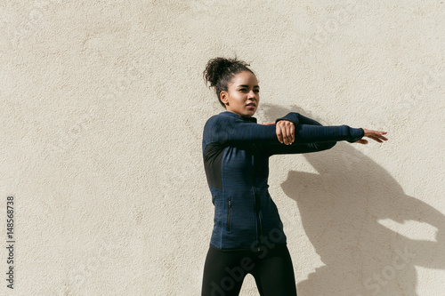 Portrait of woman warming up before running outdoors