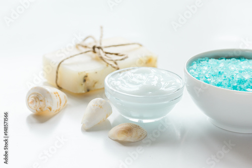 Home cosmetic with cream and blue sea salt on white background