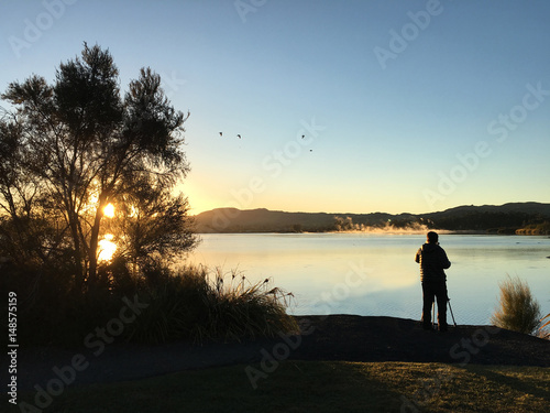 Nature and landscape photographer photographing at sunrise