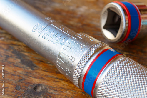 Torque wrench on a wooden table in the workshop closeup