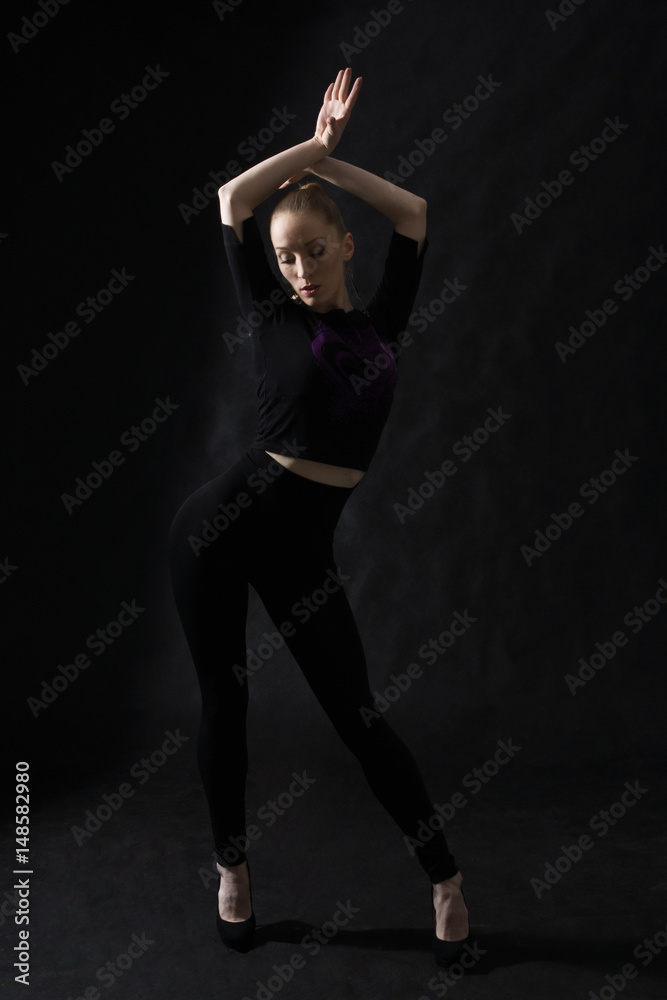 Vogue dancer posing on dark background