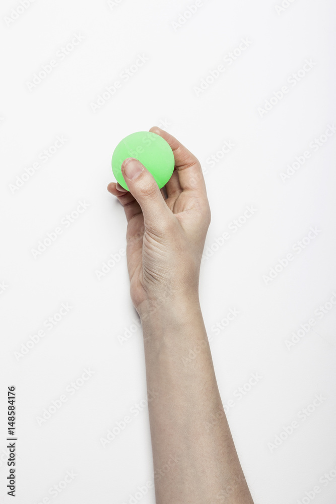 woman hand hold a fluorescence green ball isolated white, background. woman hand hold a fluorescence green ball isolated white, background.