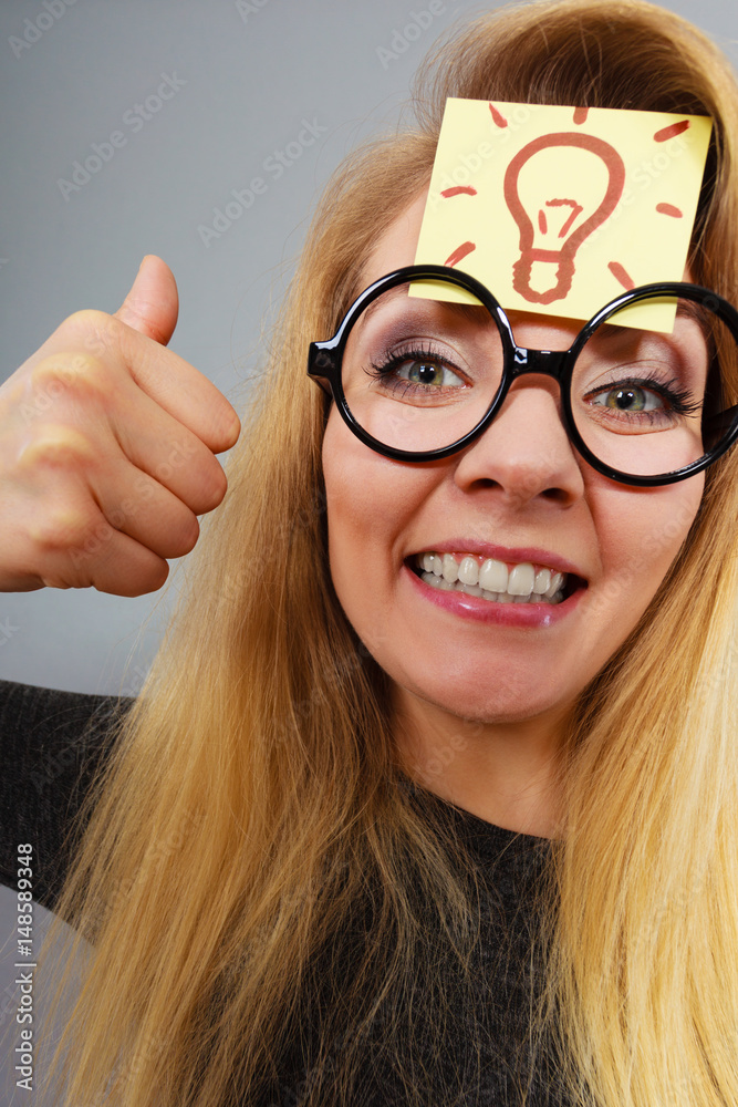 Woman having light bulb mark on forehead thinking Woman having light bulb mark on forehead thinking