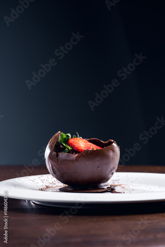 Chocolate dessert with strawberry slice  and hot chocolate sauce 