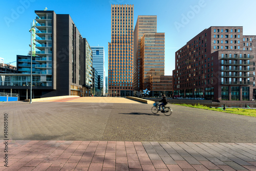 Amsterdam skyscraper, Netherlands. Office buildings in Amsterdam Zuid, Amsterdam, Netherlands. People bicycling in Amsterdam, Netherlands. photo