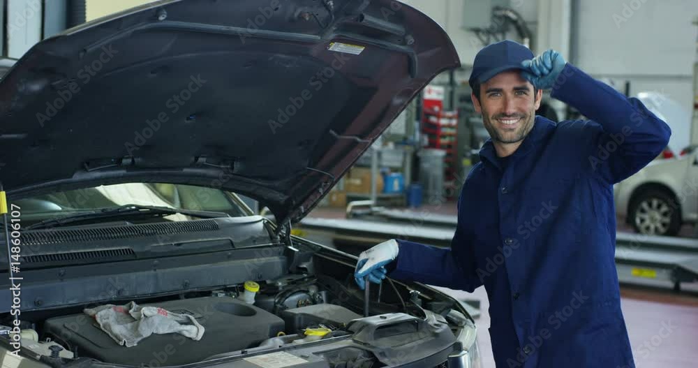 Specialist auto mechanic in the car service, checks the car, engine, engine, carburetor. Concept: repair of machines, fault diagnosis, repair specialist, technical maintenance and on-board computer. Specialist auto mechanic in the car service, checks the car, engine, engine, carburetor. Concept: repair of machines, fault diagnosis, repair specialist, technical maintenance and on-board computer.