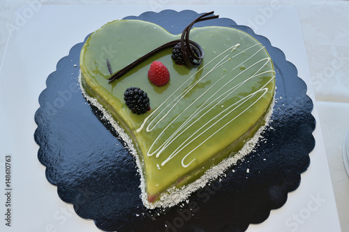 Heart shaped pie garnished with pistachio cream photo