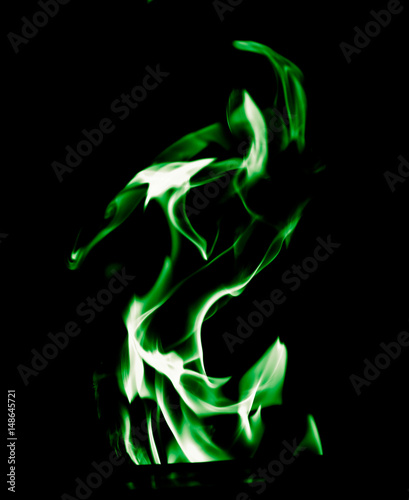 Green flame of fire on a black background © schankz