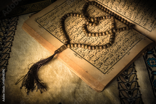 prayer beads on Koran ( holy book of Muslims ) photo