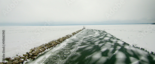 Petoskey Harbor Breakwater in spring with frozen lake photo