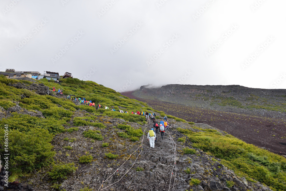 JULY 2, 2016 : People are climbing up a steep mountain fuji to reach the summit. MOUNT FUJI, YAMANASHI, JAPAN.