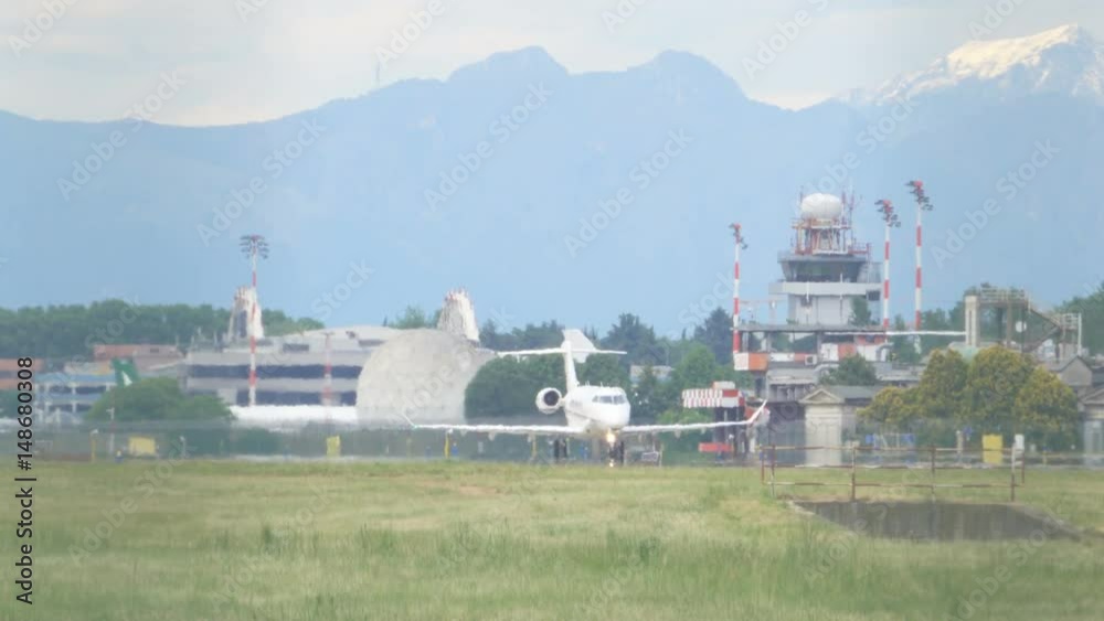 Jet Plane on Airport Takeoff Track and Mountains in the Background Jet Plane on Airport Takeoff Track and Mountains in the Background