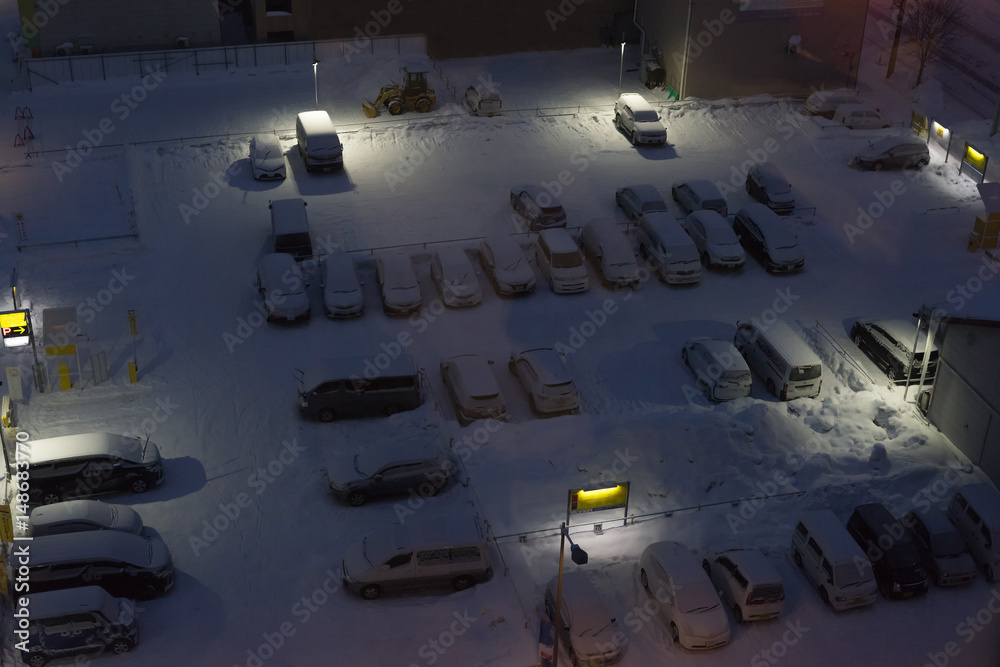 Obraz premium Parking lot covered with snow at night