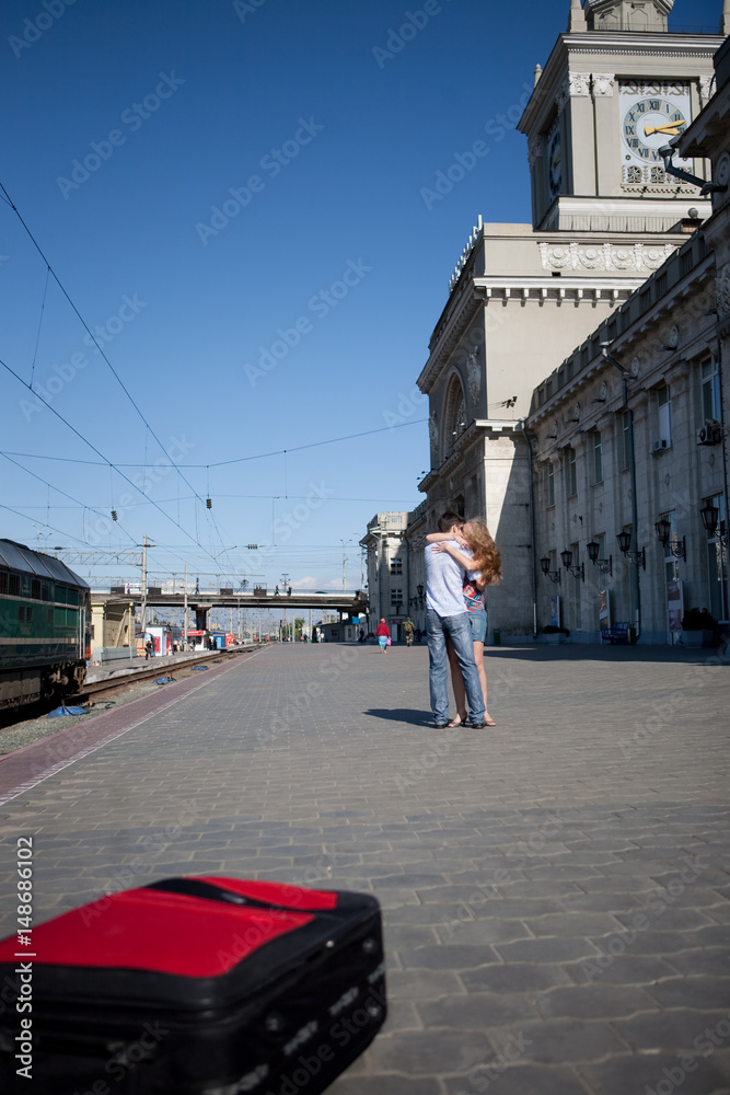 Young couple hugging on railway station