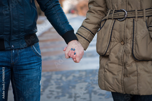 Close Up Of young Couple Holding Hands in winter