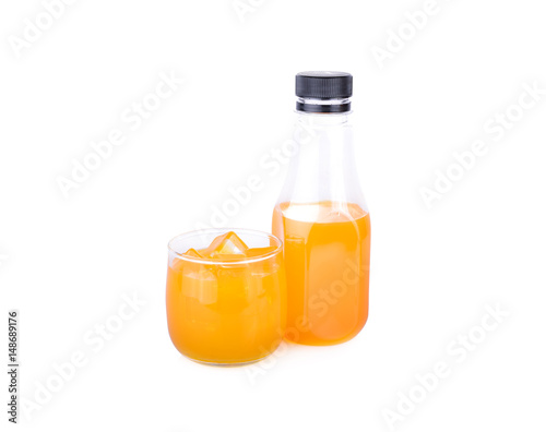 bottle and glass of orange juice on white background