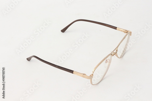 Golden eyeglasses on a white background.