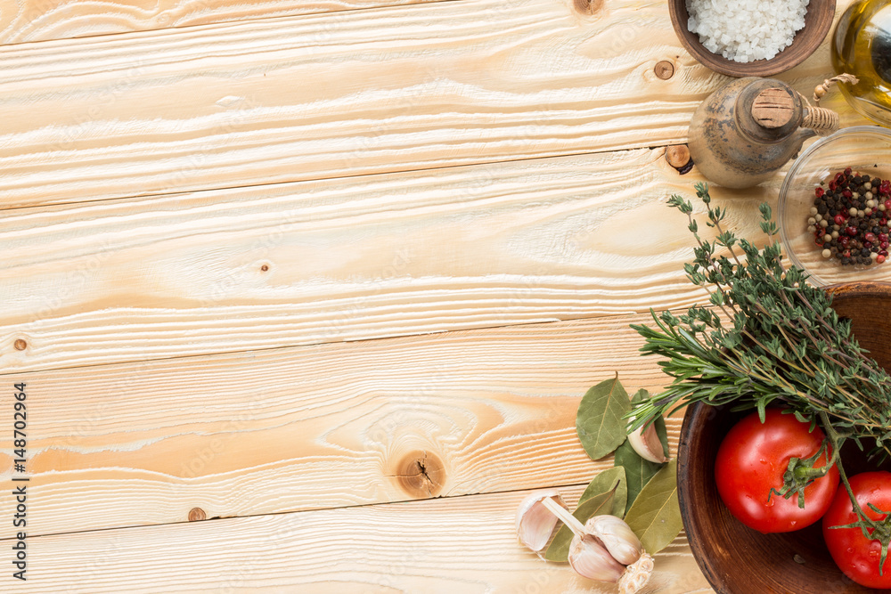 tomatoes, herbs, thyme, rosemary, sea salt, olive oil in clay jug, garlic, pepper, bay leaf on wooden background, top view tomatoes, herbs, thyme, rosemary, sea salt, olive oil in clay jug, garlic, pepper, bay leaf on wooden background, top view