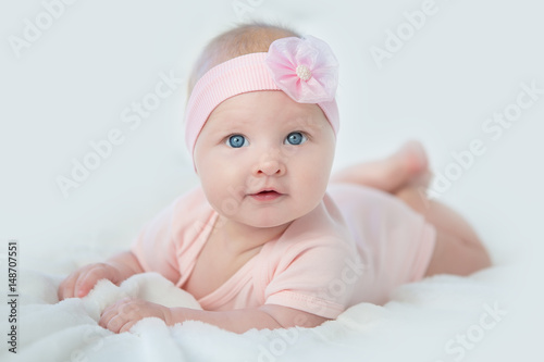 Portrait of adorable baby girl in pink dress
