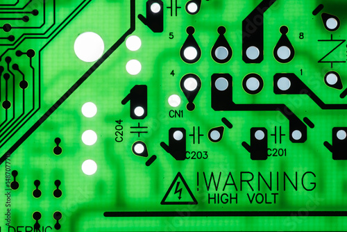 WARNING HIGH VOLT Close up of Electronic Circuits in Technology on  
Mainboard background (Main board,cpu motherboard,logic board,system board or mobo)