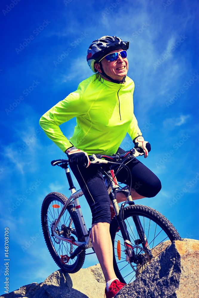 A cyclist who travels in the mountains in summer on a sunny day A cyclist who travels in the mountains in summer on a sunny day
